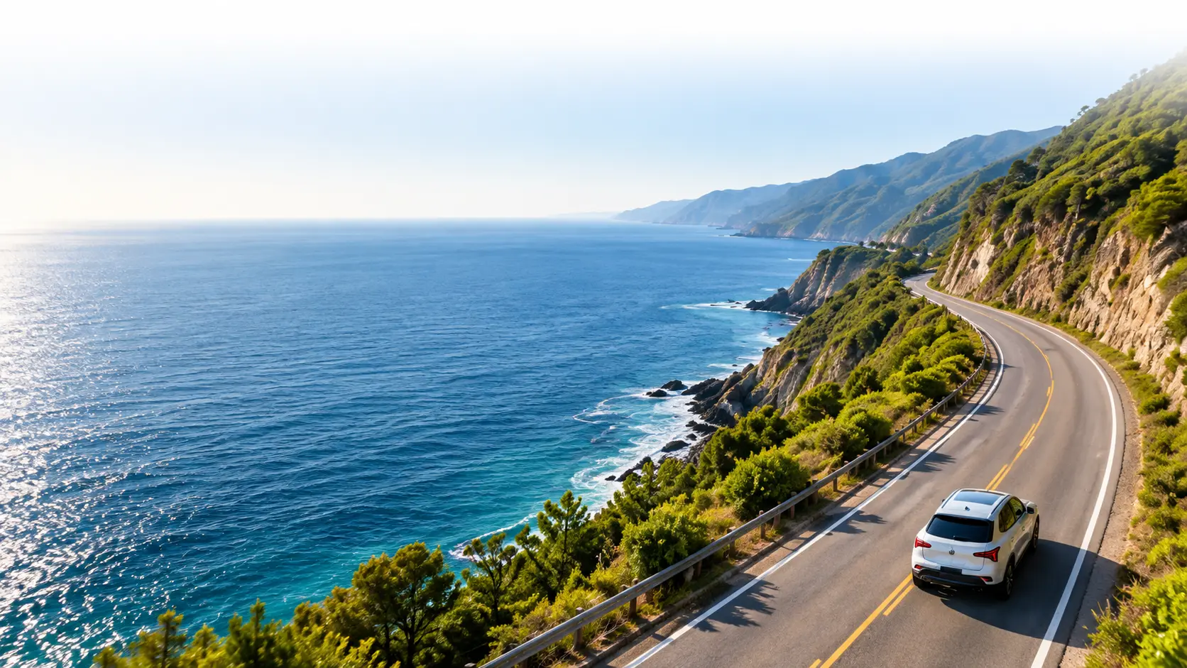 Coastal highway with a vehicle travelling along a green shoreline